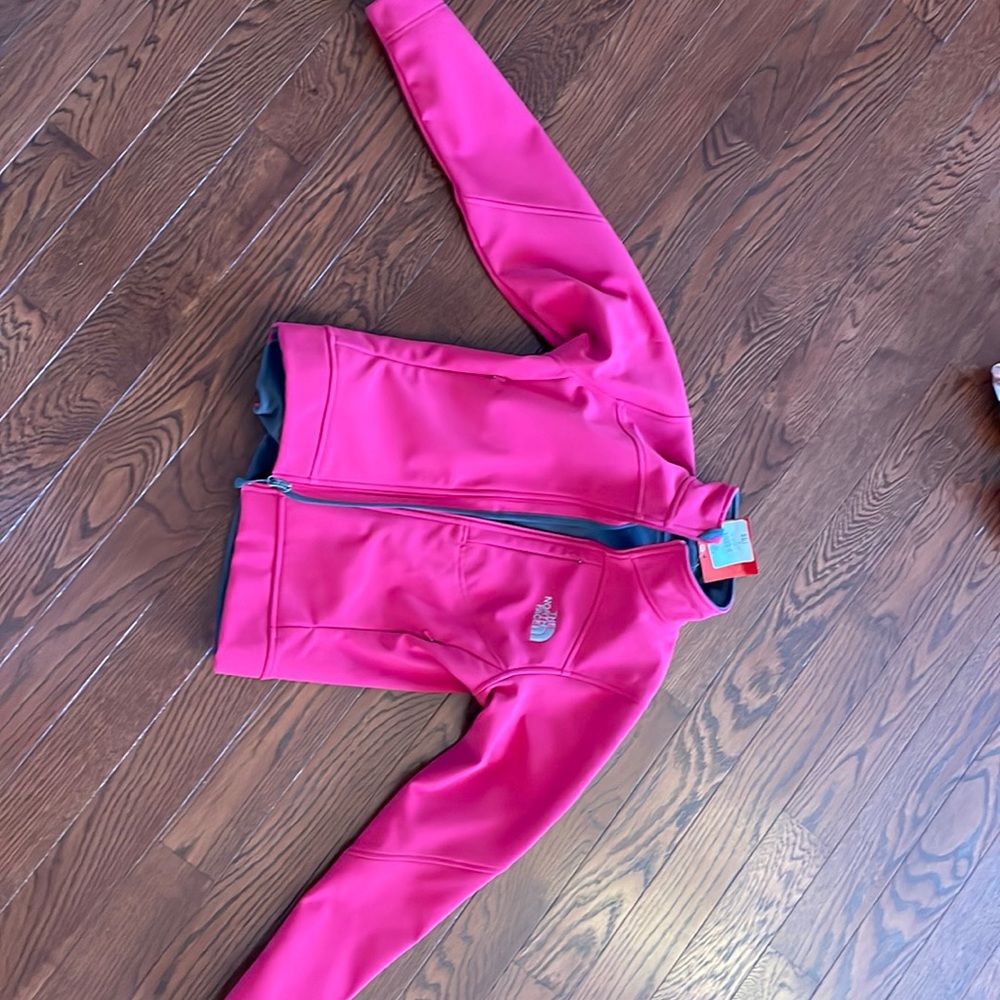 The North Face pink jacket, grey fleece lined, sipping side pocket. Never worn